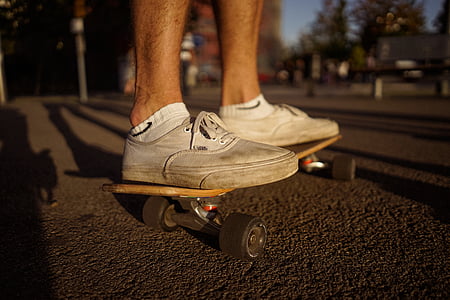 person, white, low, top, sneakers, skateboarding, road