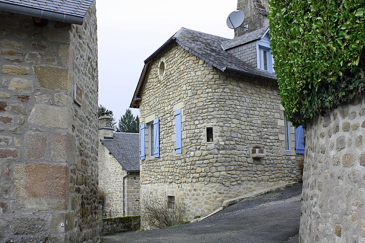 curved house wall, old stone building, french house, lavender blue shutters, cluster of houses, old village, french hamlet