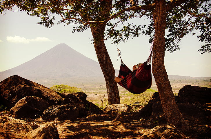 person, lying, hammock, tied, two, trees, daytime