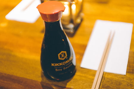 kikkoman, bottle, near, brown, chop, sticks, table