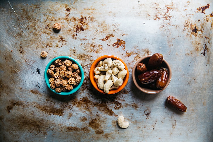 cashew, nuts, peanuts, prunes, bowl, raisins, table
