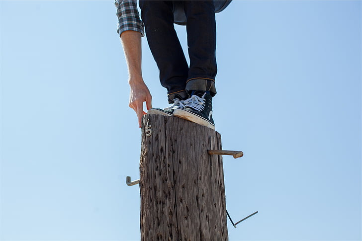 person, standing, gray, wooden, post, wood, climbing