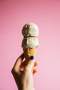 person, holding, brown, cone, vanilla, ice, cream