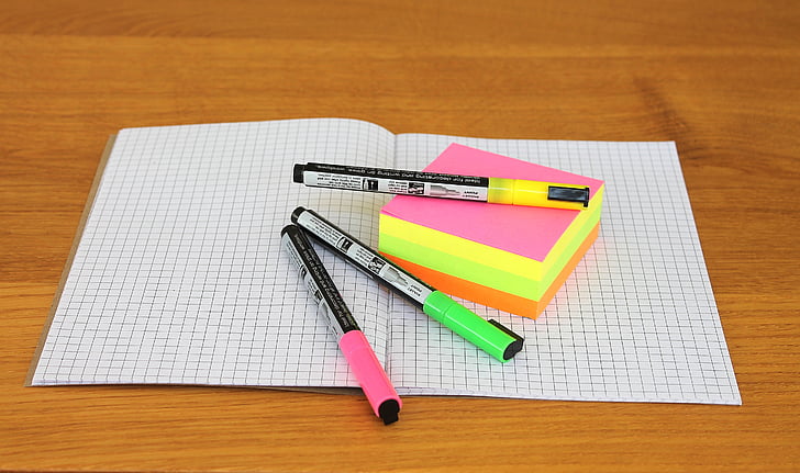 Notebook, papeles, bolígrafos, notas adhesivas