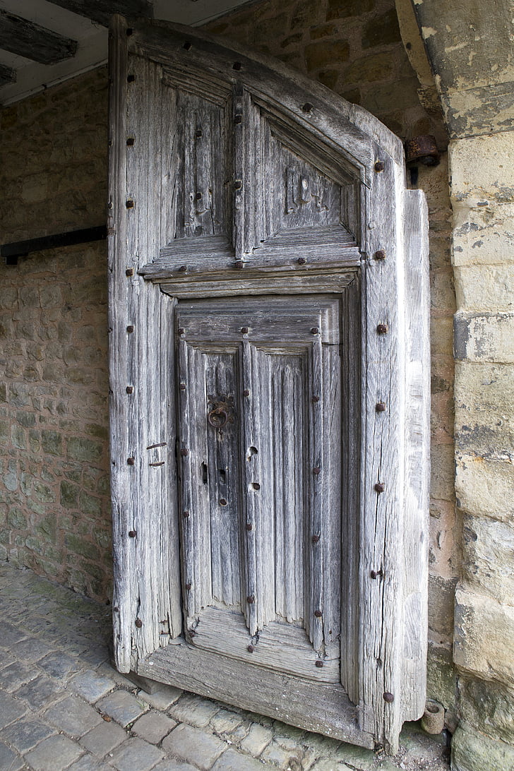 medieval oak door, iron bolts, judas gate, stonework, paving setts, ightham mote, kent