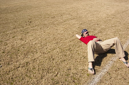 man, sleeping, grass, field, daytime, hat, nap