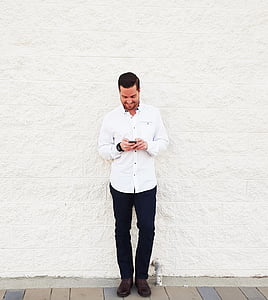 Jeune homme, regarder téléphone, mur de briques, mur blanc, Mobile, Smart, Téléphone