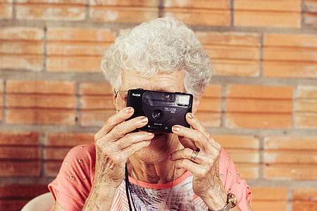 grandmother, holding, point, shoot, camera, hair, woman