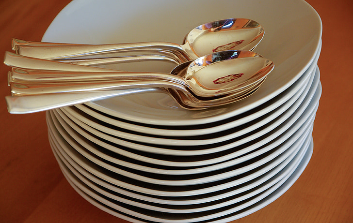 plates, spoons, silverware, stack