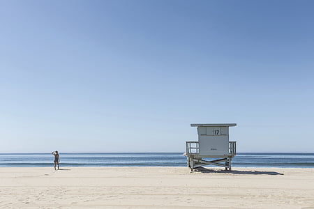 beach, coast, lifeguard tower, ocean, person, sand, sea