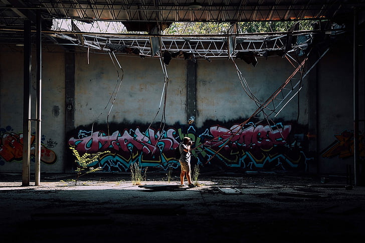 man, taking, photo, near, wall, graffiti, people