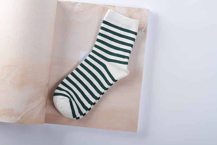 dark green, in tube, sock, black, stripes, woman, napkin