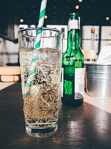 drinking, glass, green, white, straw, beside, labeled
