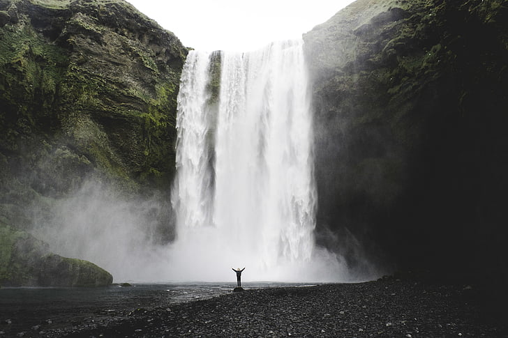 person, standing, stone, water, falls, daytime, waterfall