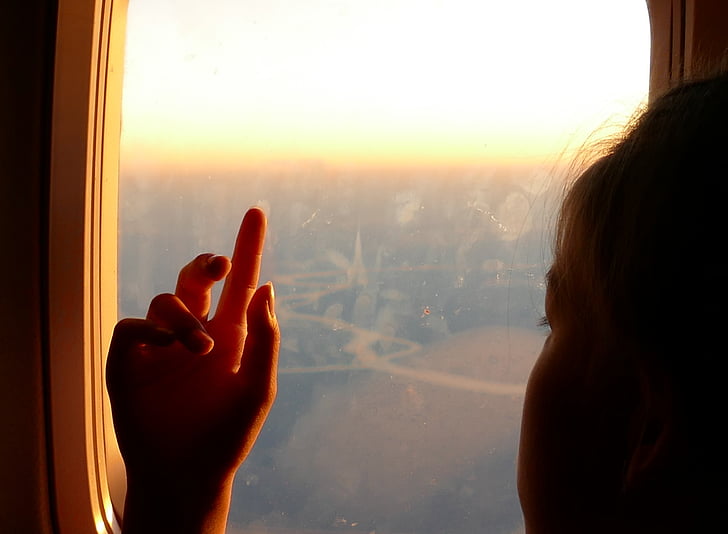djevojka, ruku, prozor aviona, dijete, pokazuje, prst, razmišljanja