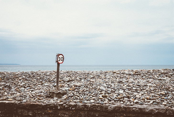 speed limit, rocks, ocean, sea, water, blue, sky