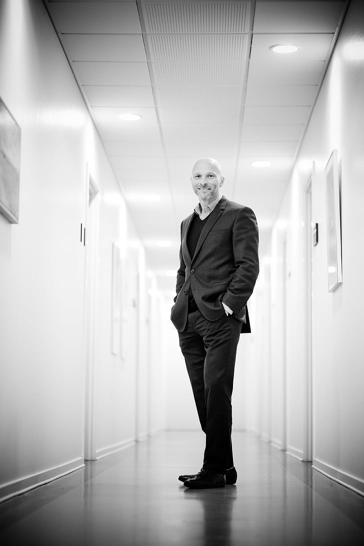 accountant, adult, black-and-white, business, corporate, corridor, facial expression