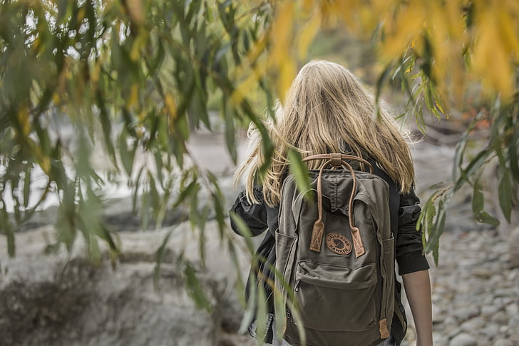 backpack, blonde, blonde hair, close-up, environment, field, growth