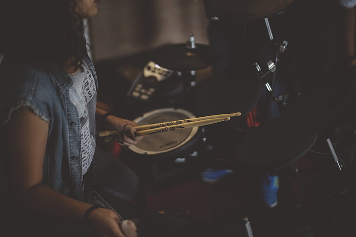 person, holding, drumsticks, sitting, front, drum, sets