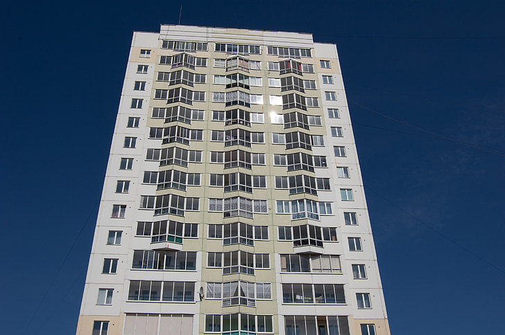 building on a background of blue sky, bottom view, high-rise, multistory building, street, window, modern building