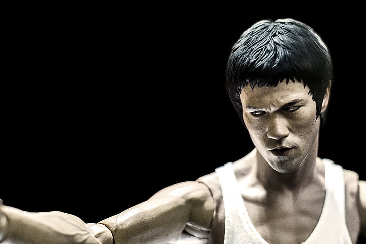 person, showing, bruce, lee, figure, black background, one young man only