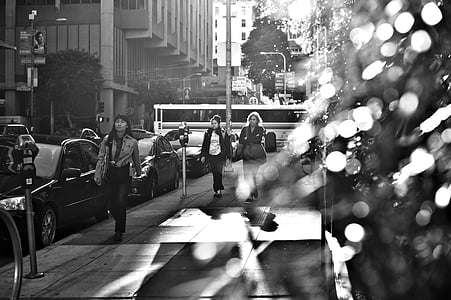 adult, black-and-white, blur, bokeh, buildings, car, city