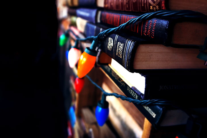 book stack, books, christmas lights, dark, indoors, lights