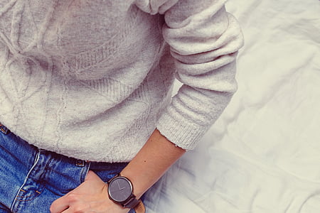 person, white, sweater, blue, jeans, sitting, comforter