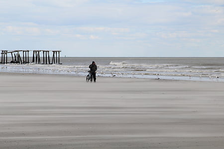 person, bike, standing, seashore, daytime, sea, ocean