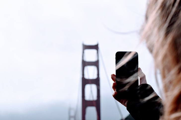 bridge, architecture, blur, phone, hand, hair, sky