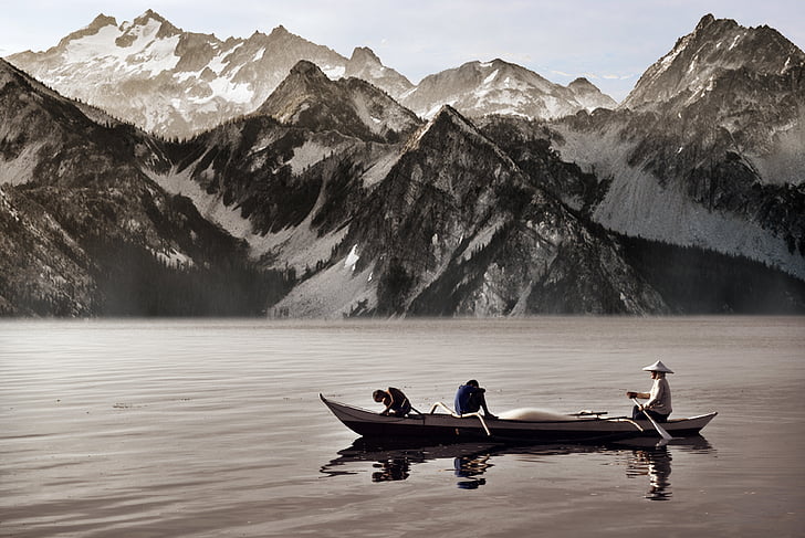 grayscale, photo, man, fishing, near, rocky, mountain