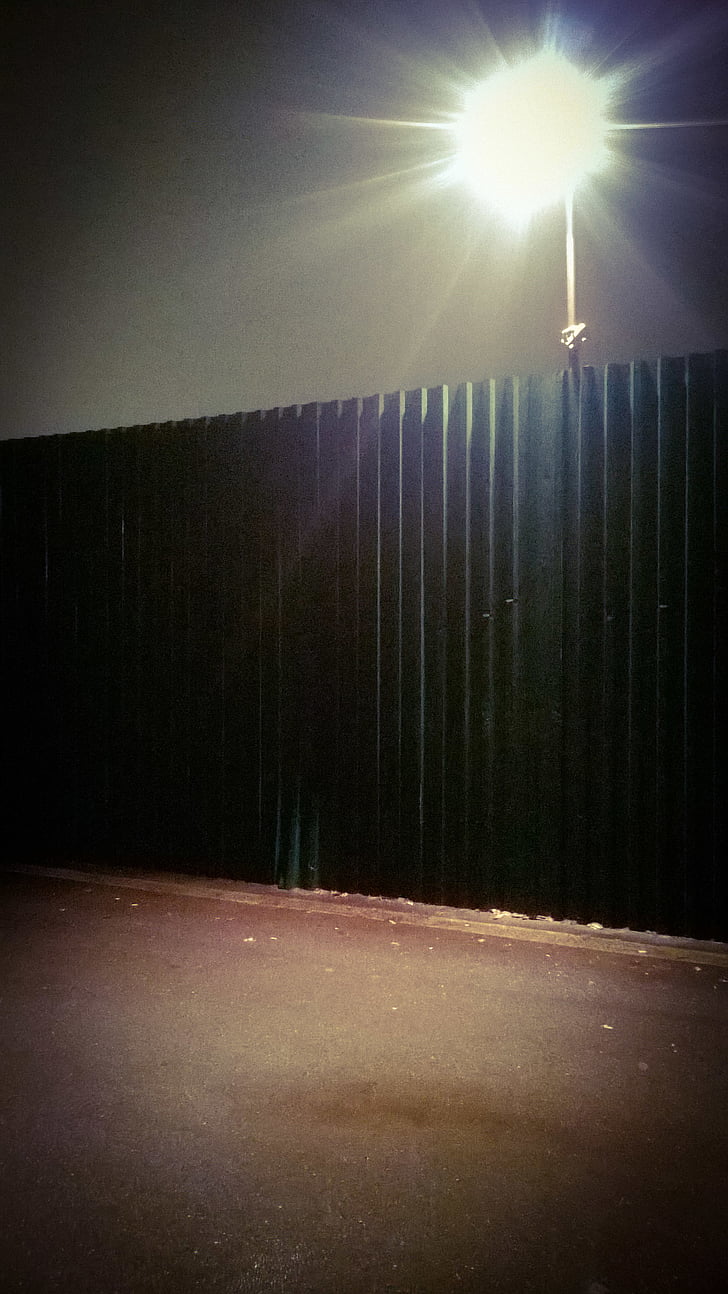 corrogated steel fence, fence, glare, night, security light, streetlight, wall