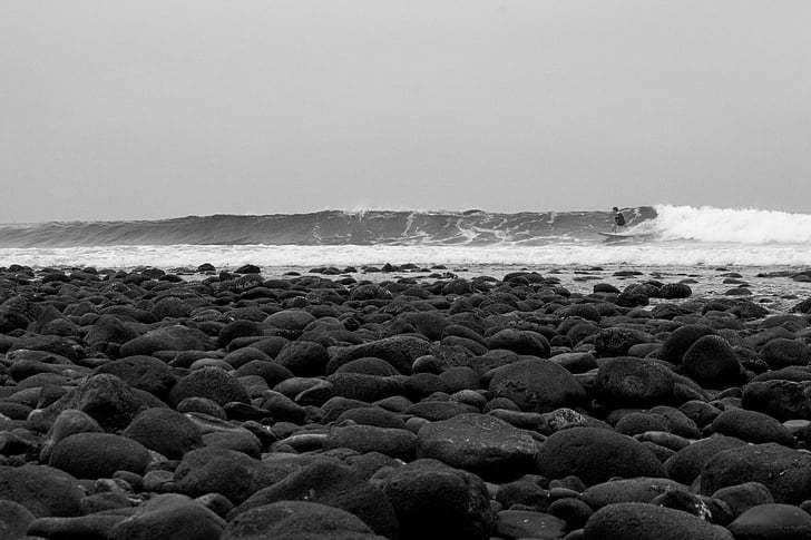 beach, black-and-white, ocean, person, rocks, sea, surfer