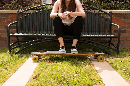 woman, sitting, metal, bench, feet, skateboard, steel