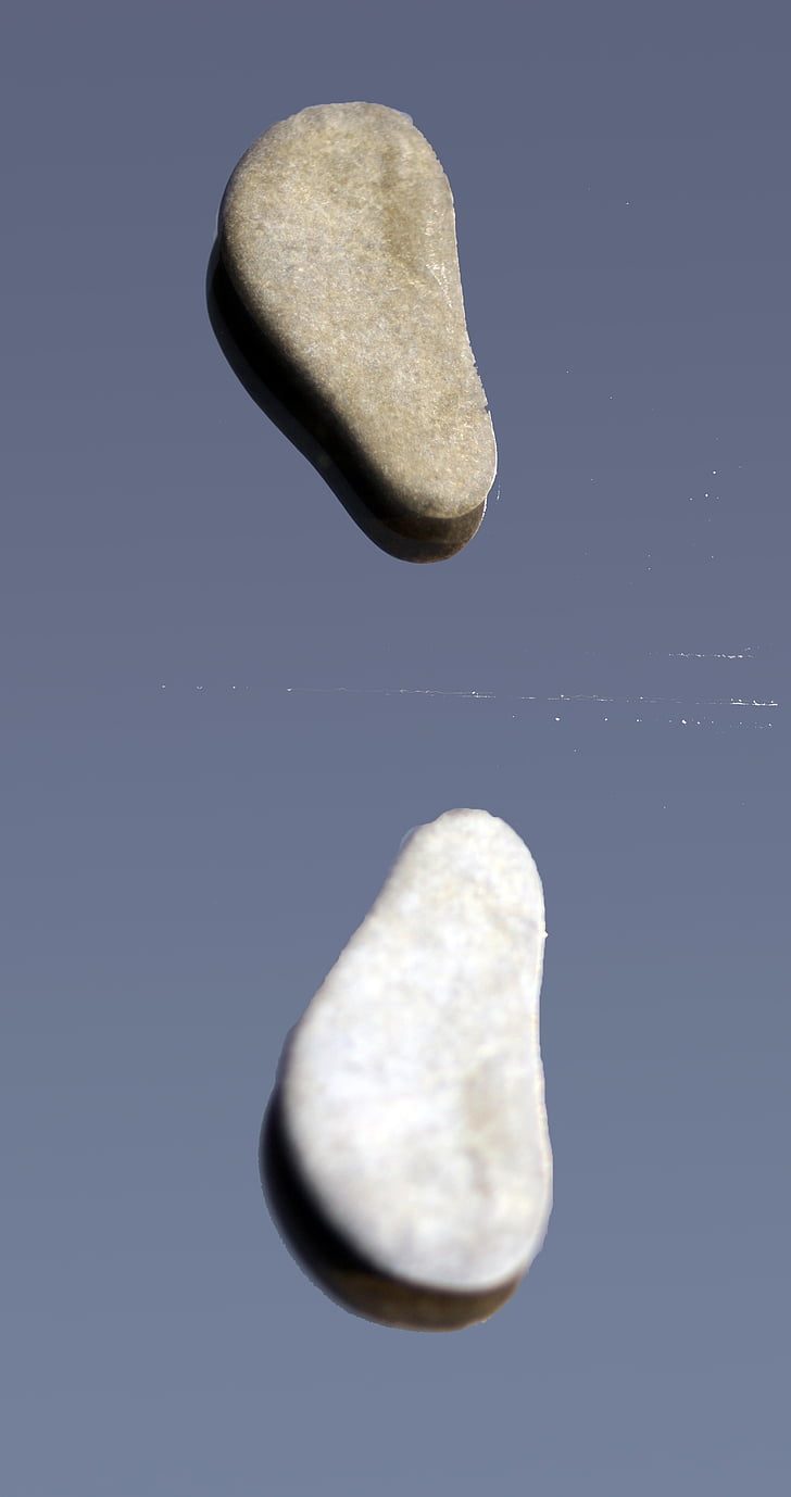 stones, feet, pair, scattered, mirroring