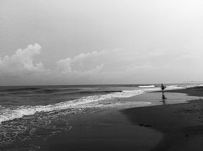 grayscale, photo, person, holding, surfboard, walking, beside