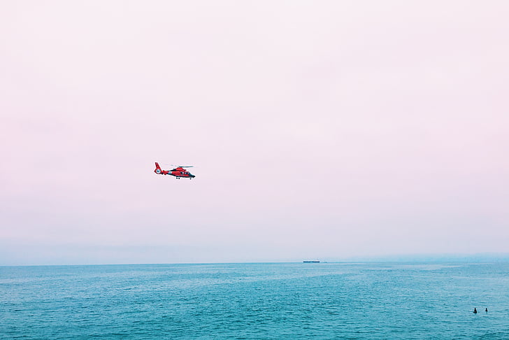 red, helicopter, flying, body, water, daytime, sea
