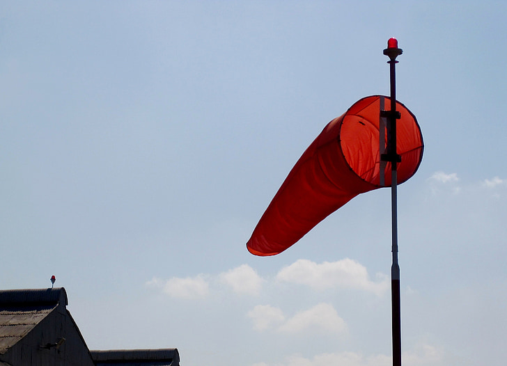 windsock, orange, pole, blue sky, hanger roof, blowing