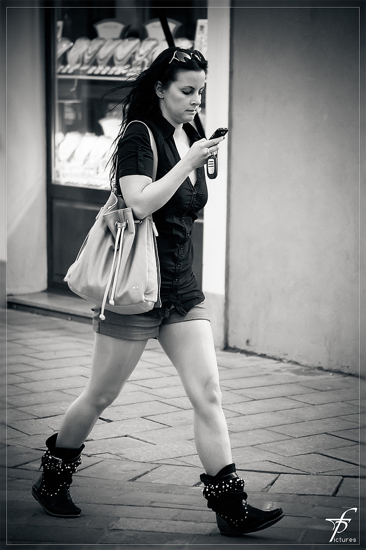 girl, woman, street life, downtown, black and white, telephoning, busy