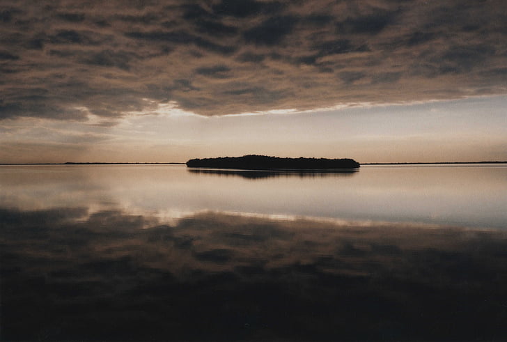 dark clouds, daylight, island, lake, nature, ocean, reflection