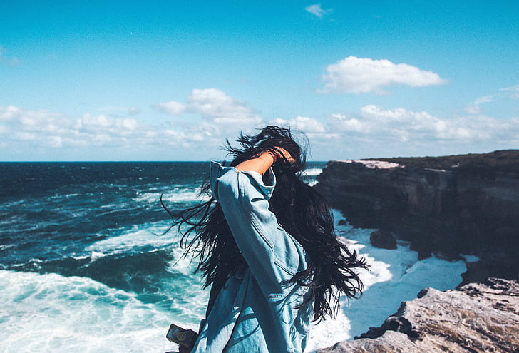 woman, standing, cliff, sea, daytime, ocean, water