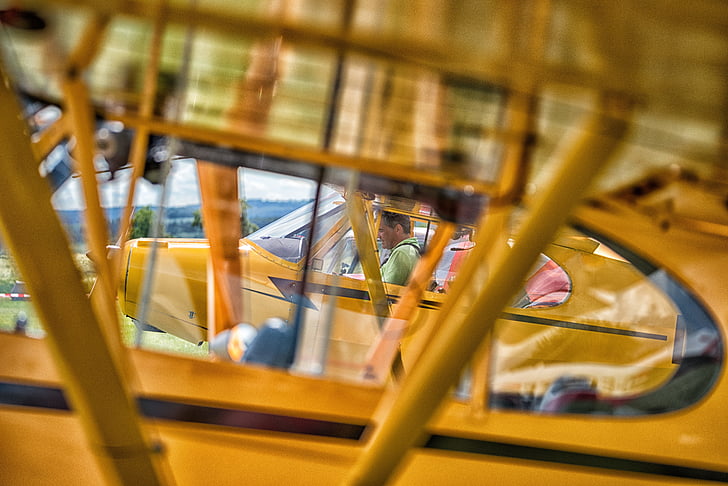 piper cub, aircraft, launch preparation, yellow, indoors, close-up, no people