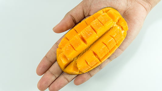 mangue, tranche, sur la main, jaune, isolé, Cube, fruits