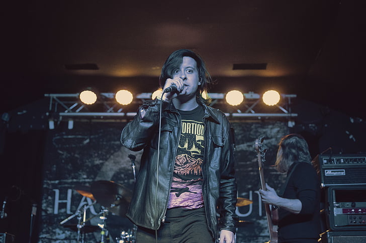man, wearing, black, leather, jacket, singing, stage