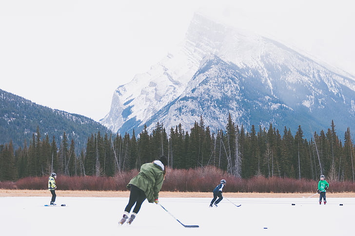 four, people, playing, hockey, outdoor, near, mountain